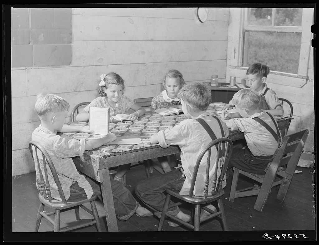 A one-room school in Breathitt County, Kentucky, August 1940. Six children at a table, and no caption at all.