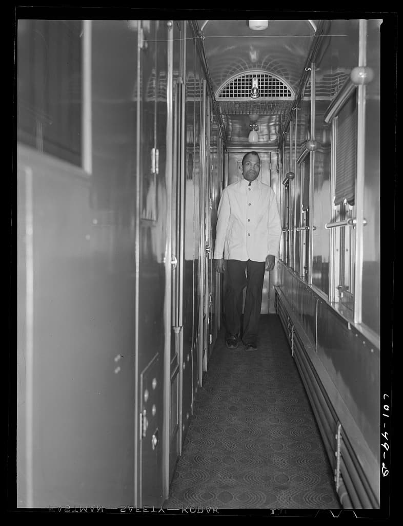 Mr. Alfred MacMillan, Pullman porter, going to answer a call aboard the Capitol Limited, March 1942.