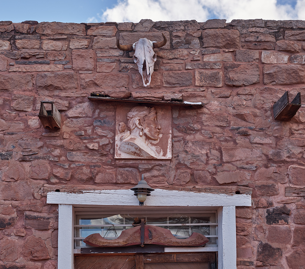 A doorway of the post, with a skull set above it.