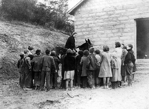 A carrier at a mountain school, 1938. Children took books for themselves and books to read to their parents.