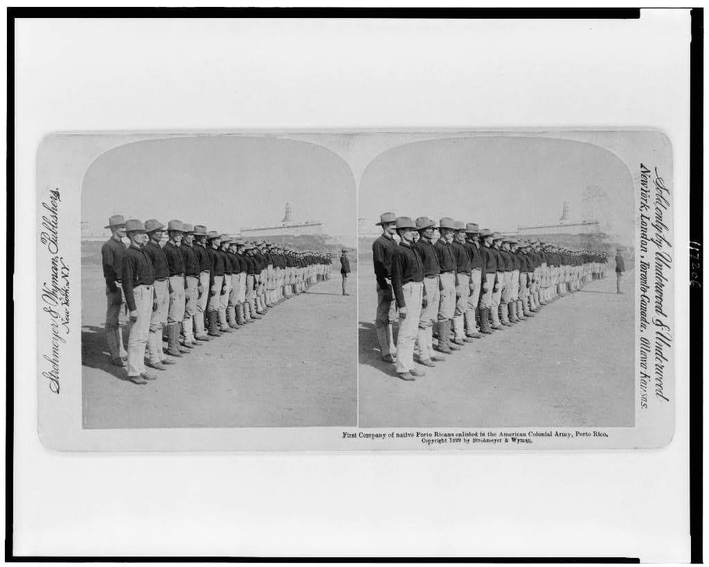 The first company of Puerto Ricans enlisted, 1899, on a stereograph. The 65th descends from it.