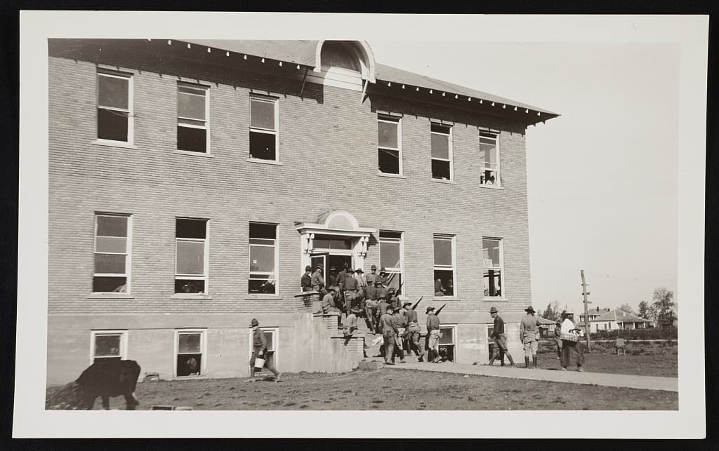 Troops entering the guard house and hospital at Elaine, Arkansas, 1919.