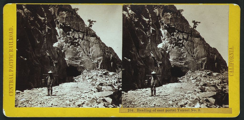 The east portal of Tunnel No. 8. The summary says a Chinese railroad worker with a shoulder pole.