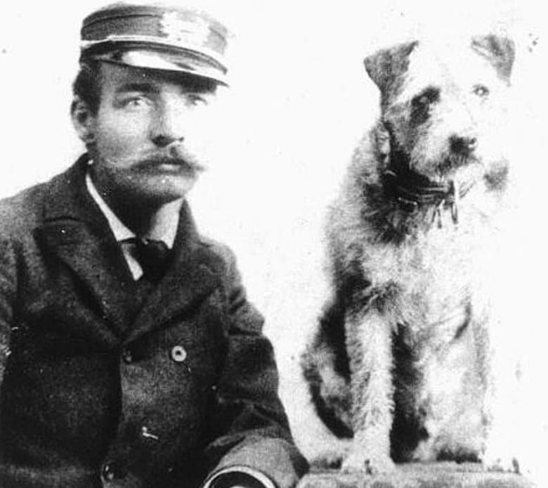 Owney with a mail carrier. He belonged to the Railway Mail Service more than to anyone.