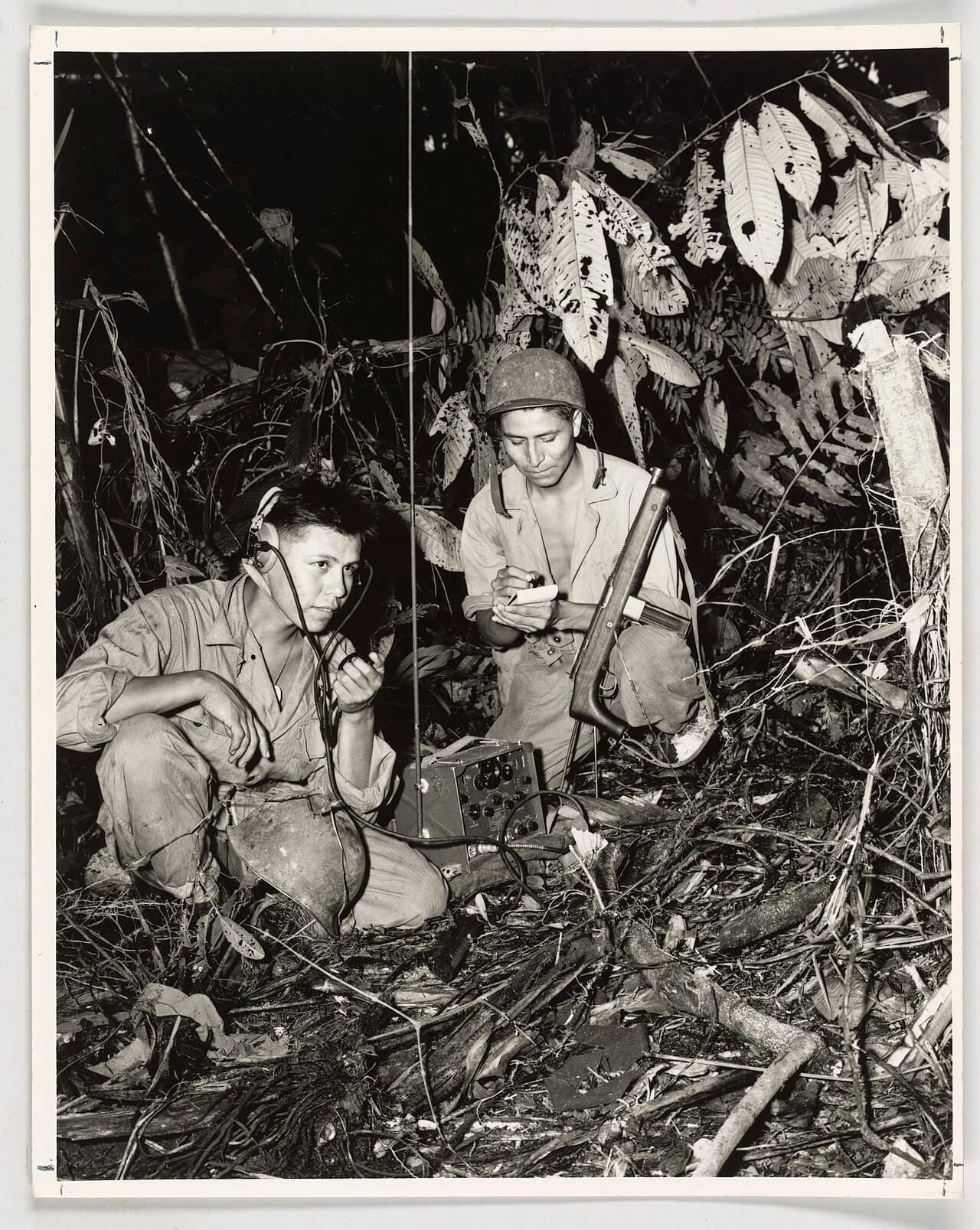 Henry Blake Jr. and George H. Kirk with a portable radio, Bougainville, December 1943.