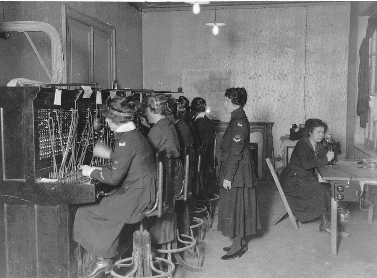 At the switchboard in January 1919. The Signal Corps caption names every woman in the frame.