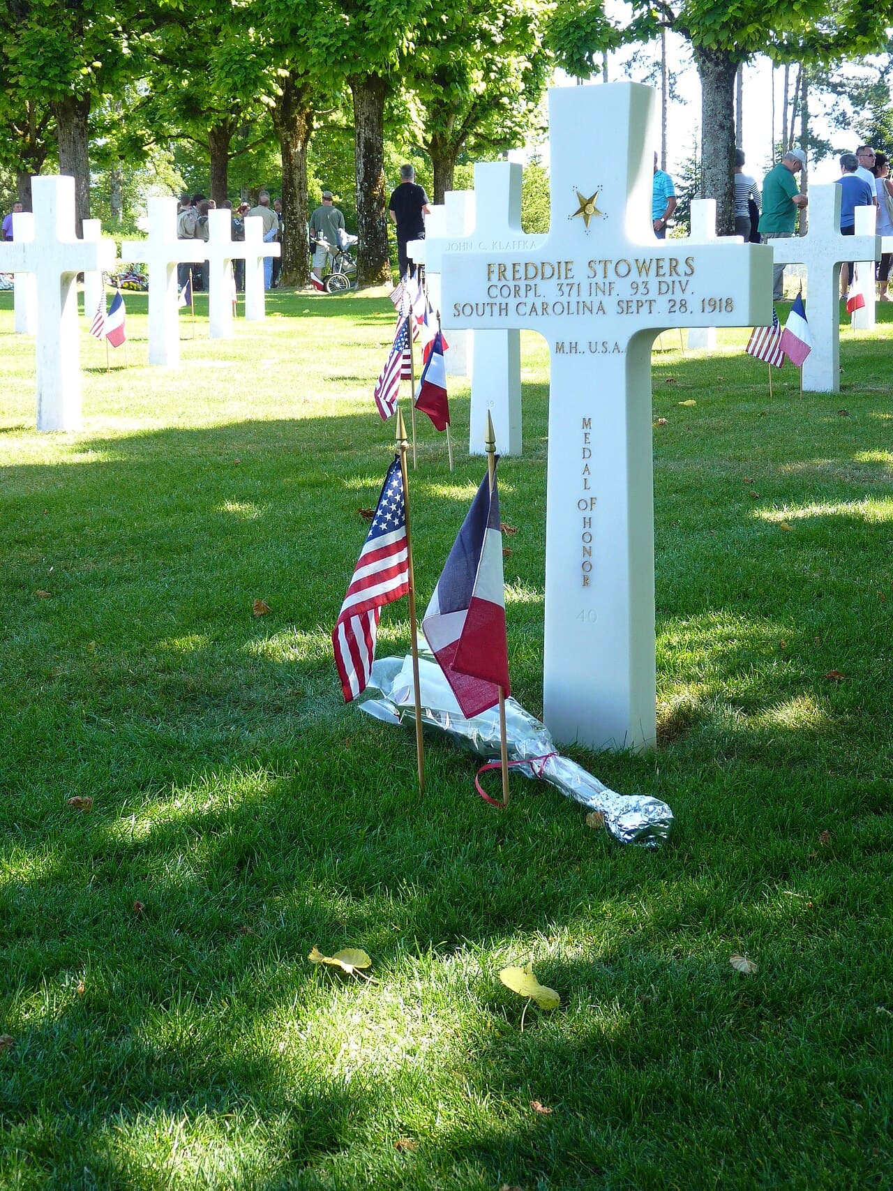 His grave at the Meuse-Argonne American Cemetery in France, with American and French flags.